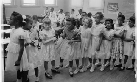 Black and white schoolgirls lined up in a classroom