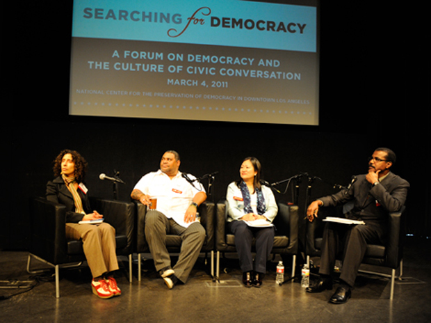 participants on stage from Searching for Democracy conference