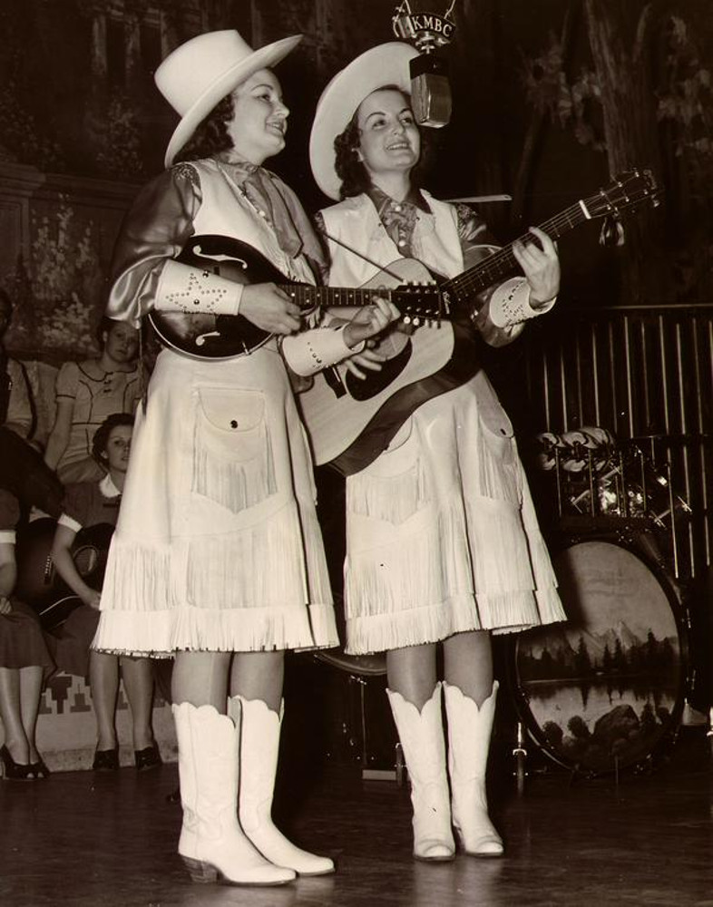 Kitty & Kay performing with guitar and mandolin.