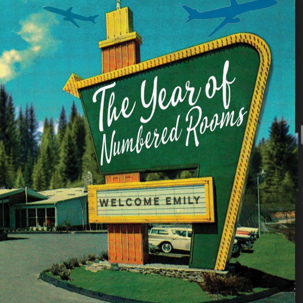 A green motel sign with the phrase, "The Year of the Numbered Rooms" written on it.