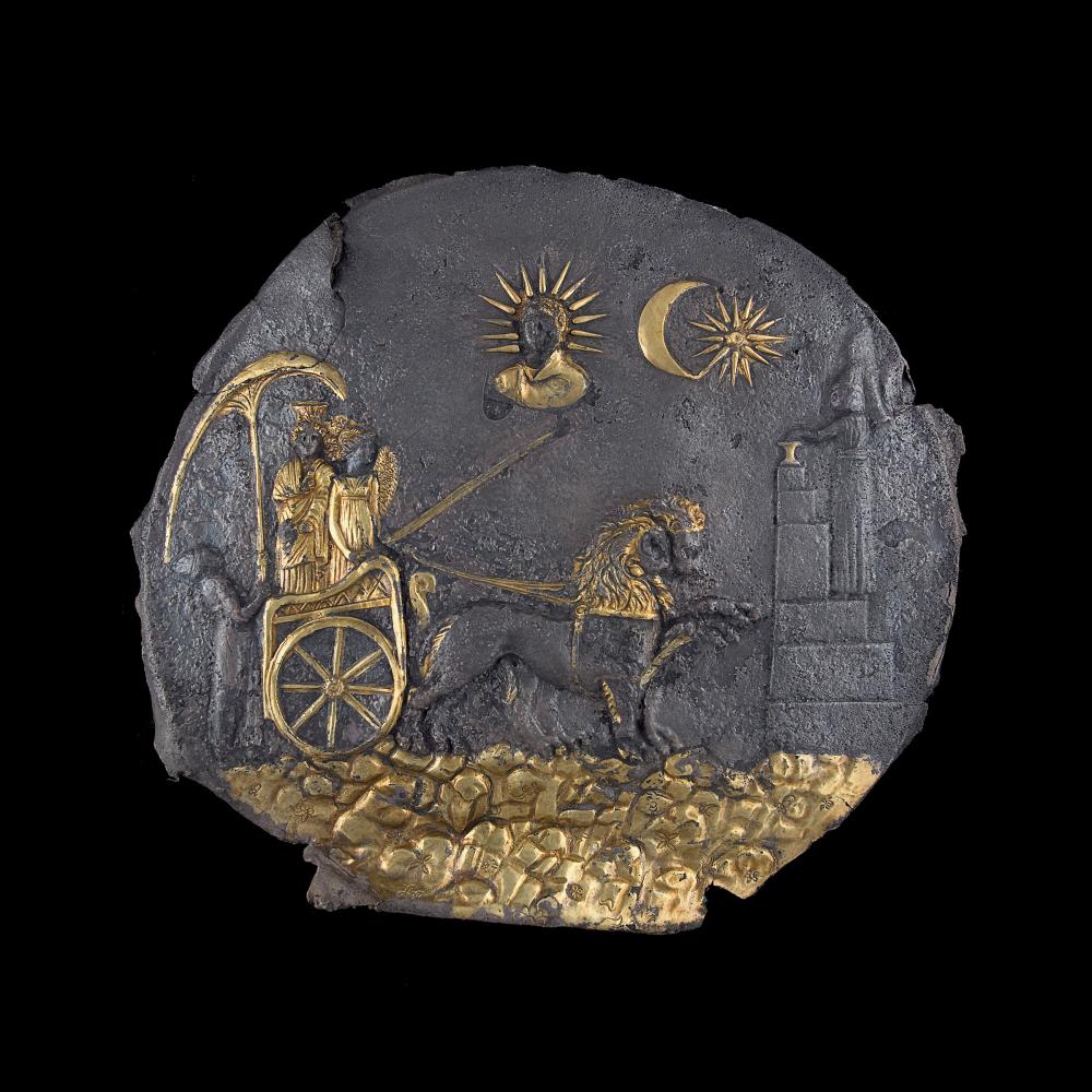 ancient plaque with gold embellishments, two figures in chariot