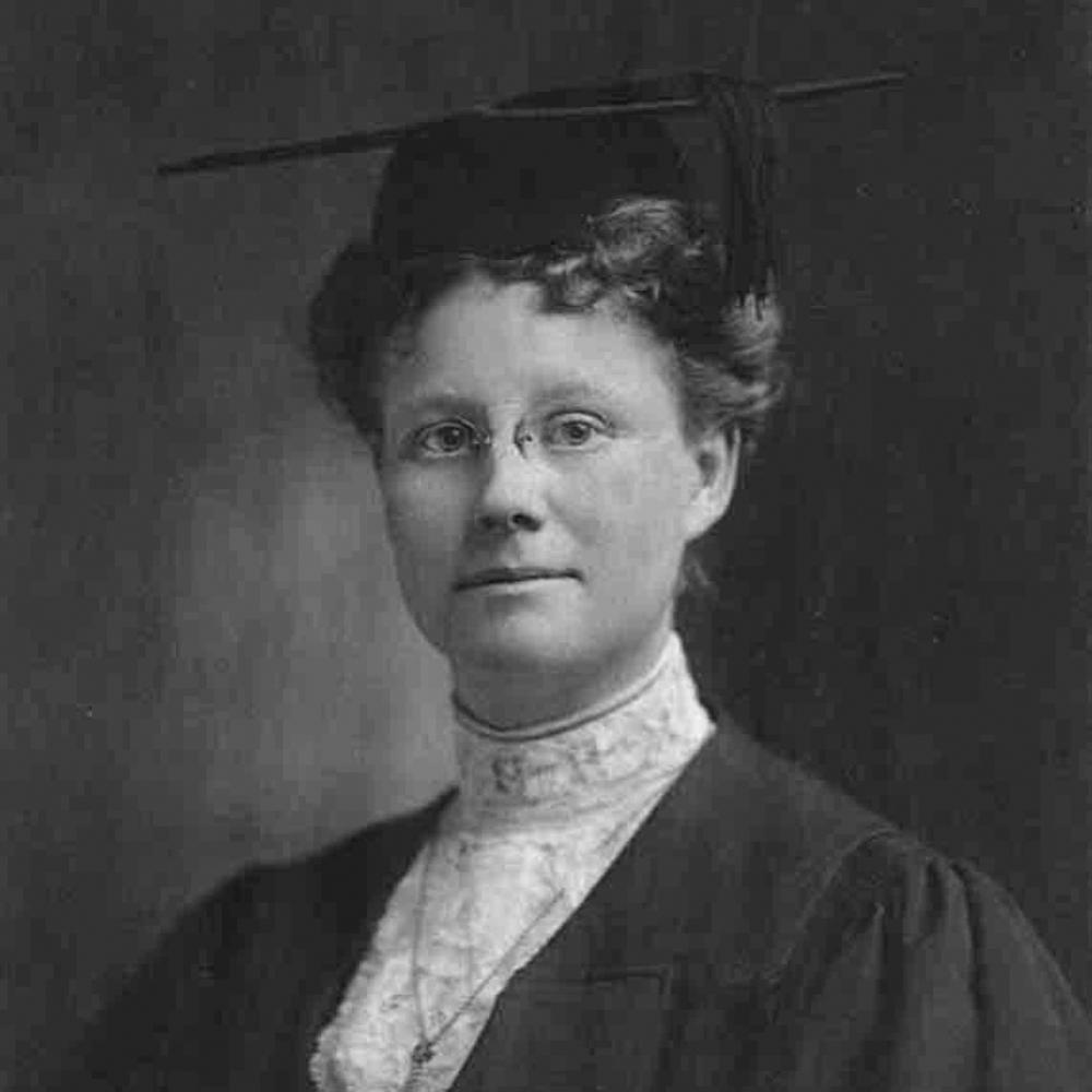 Formal portrait of Dr. Darrow, wearing a pair of small eyeglasses, black dress and lace collar
