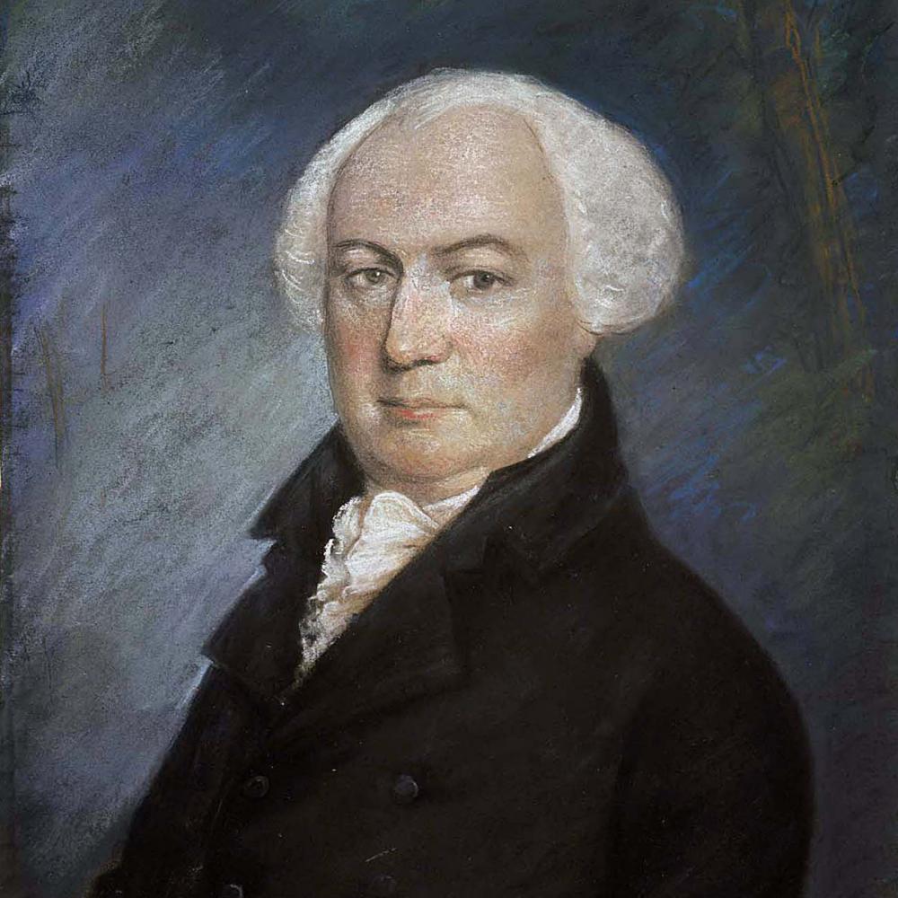 Portrait of a balding man in a black 18th century suit.