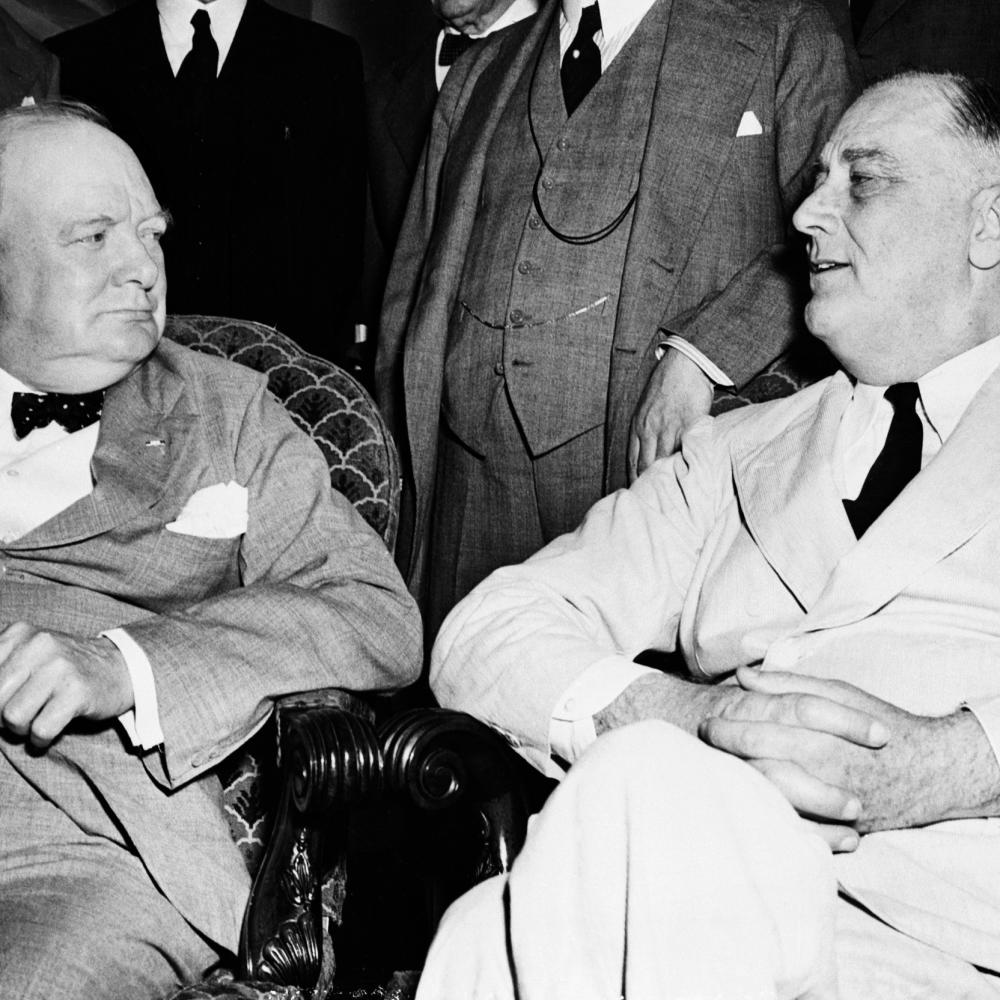 Black and white photo of Winston Churchill and Franklin D. Roosevelt sitting together.