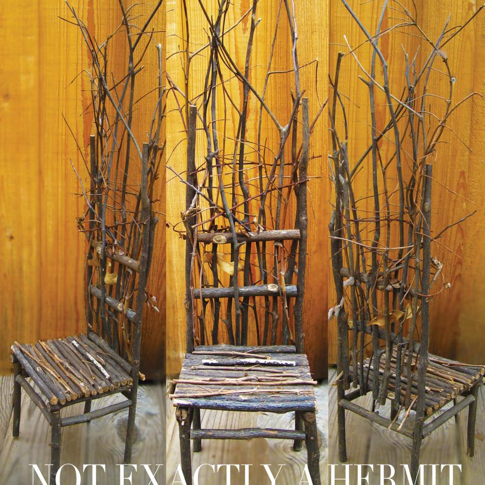 Photo of three chairs made of tree branches with a plywood background and the text "Not Exactly a Hermit" written at the bottom.