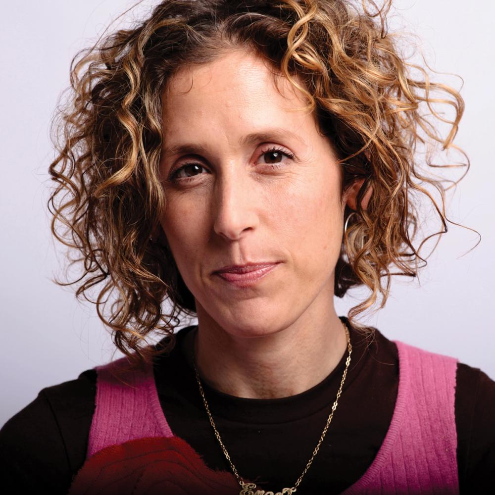 Professional photo portrait of Cara Ungar, who has curly hair.