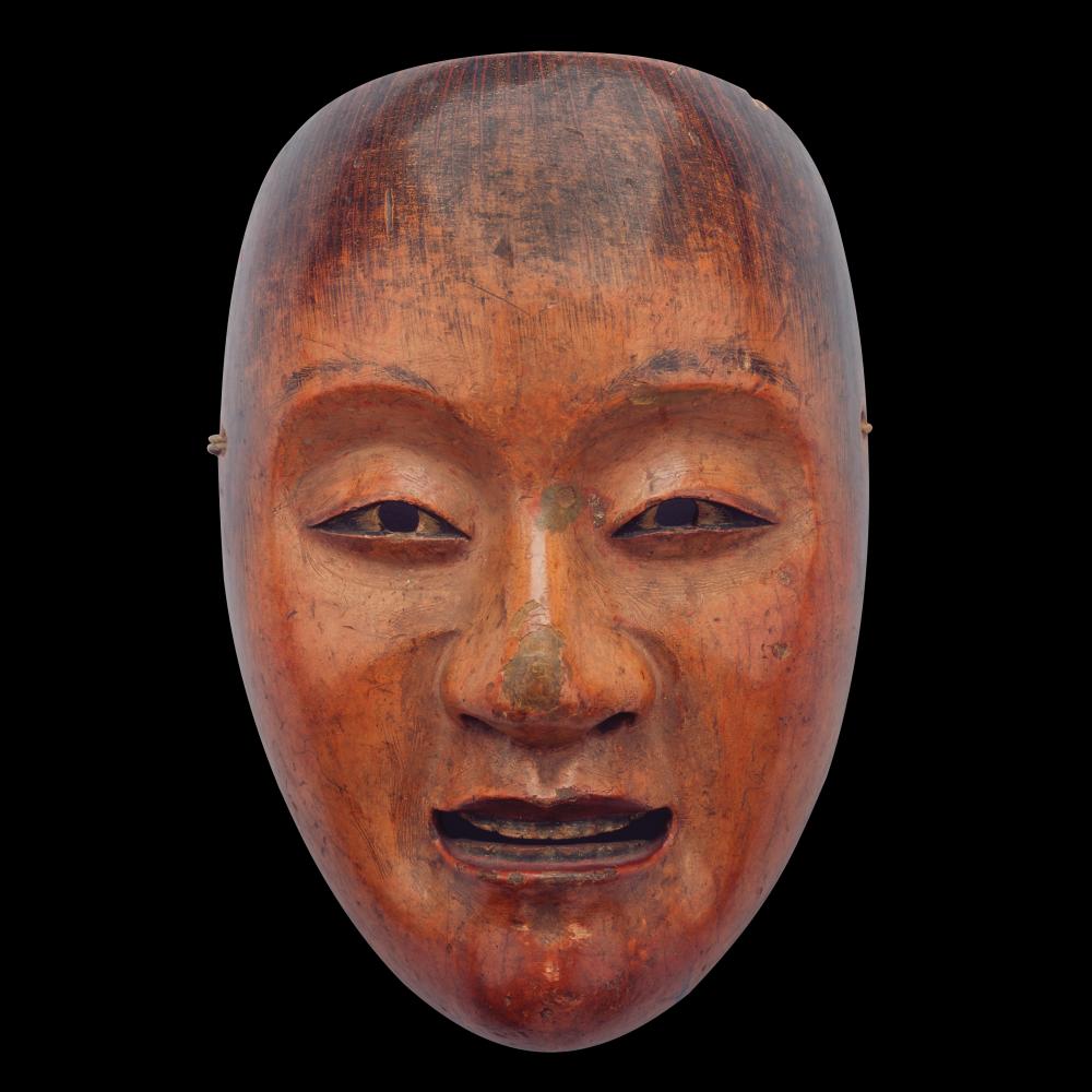Color photo of a humanoid mask that changes its expression when viewed at different angles.