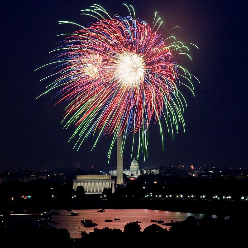 An explosion of fireworks against the night sky above the national mall in Washington, D.C.