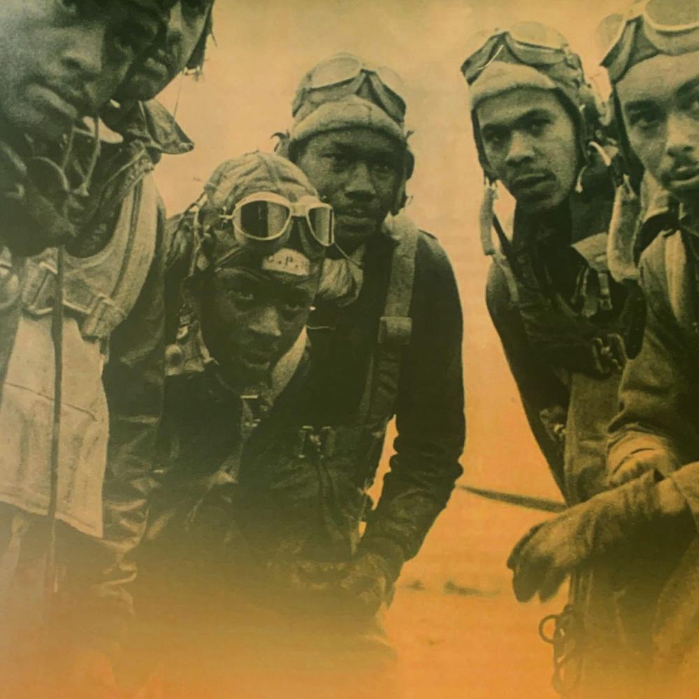 Black and white photo of six Tuskegee Airmen in Italy. 