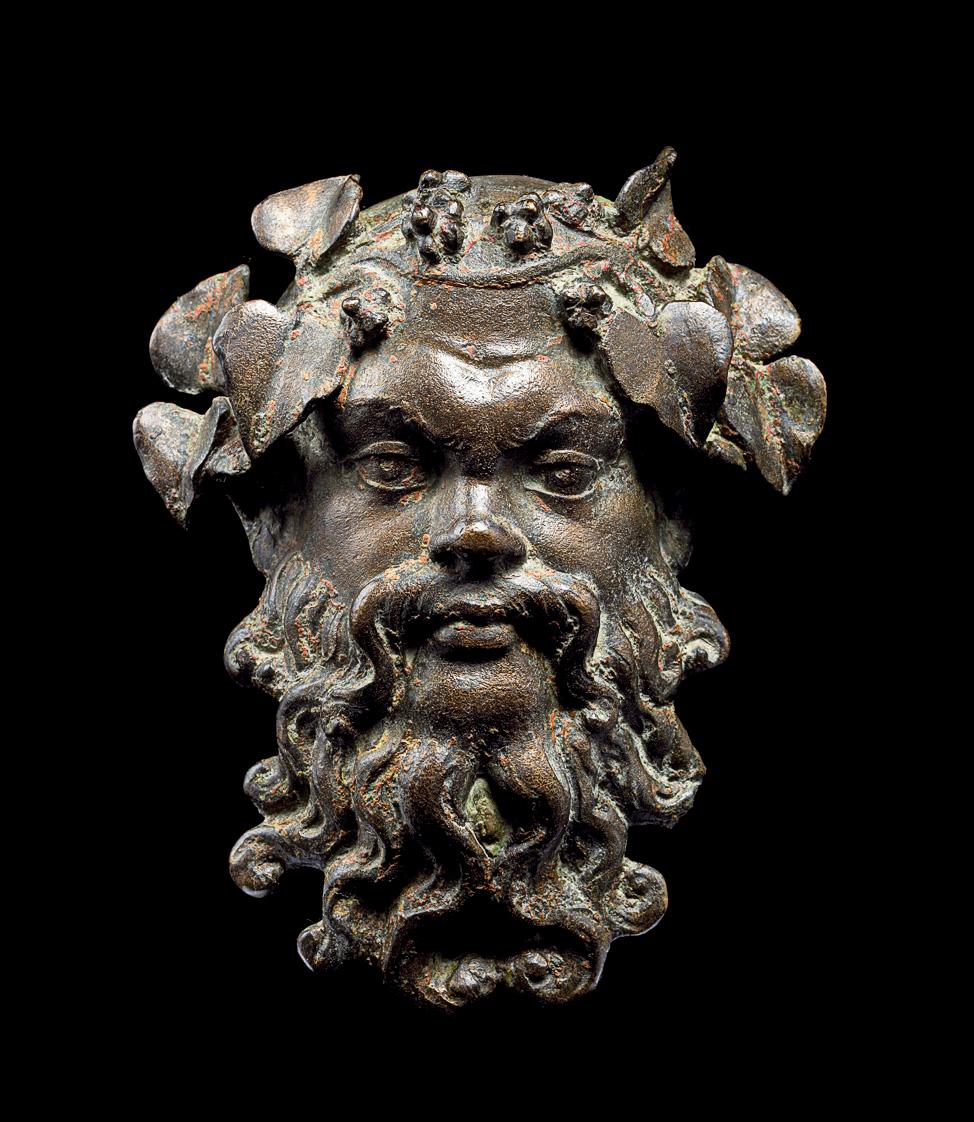 Photograph of a bronze mask of a man with a beard