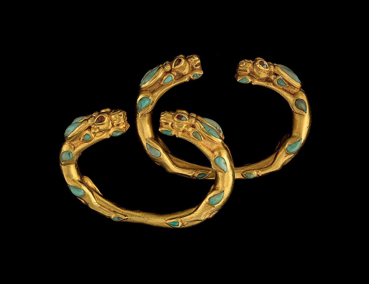 two golden bracelets with turquoise stones inlaid