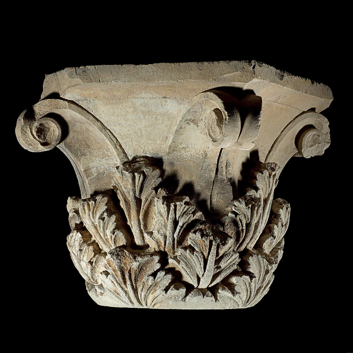 Photograph of a corinthian capital, leaves carved from stone