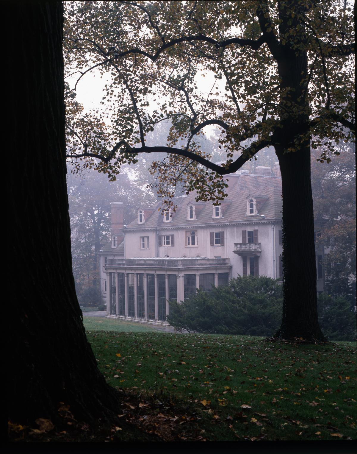 Photograph of a large house, shrouded in slight mist