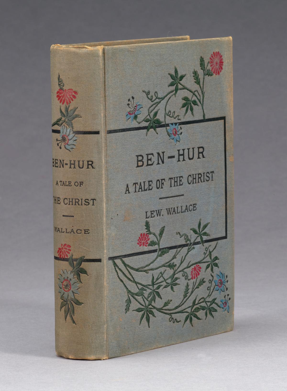 Cream colored cover and spine, decorated with twining vines and flowers, which border the title and author text