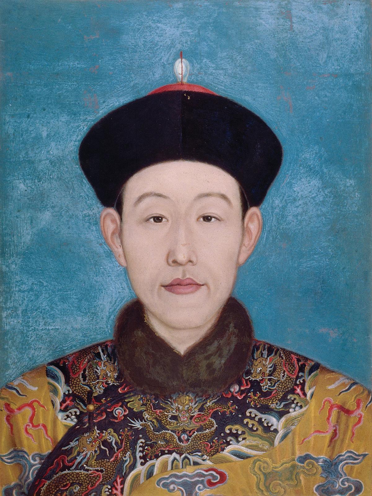 Head and shoulders portrait of the emperor, wearing a rounded black cap, brown fur collar, embroidered coat