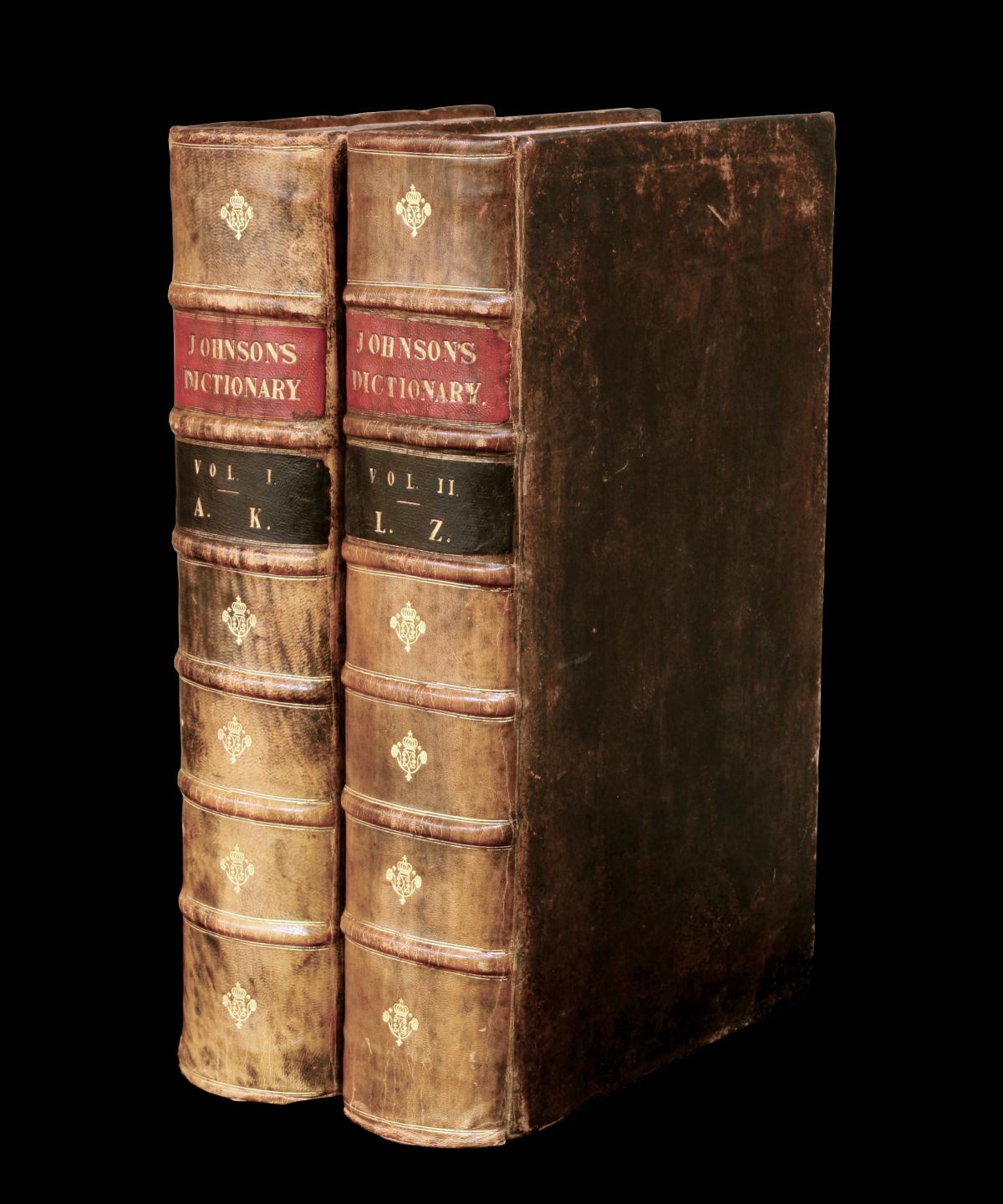 two volumes of the 1755 dictionary, bound in brown leather with red, black and gold bands on the spines