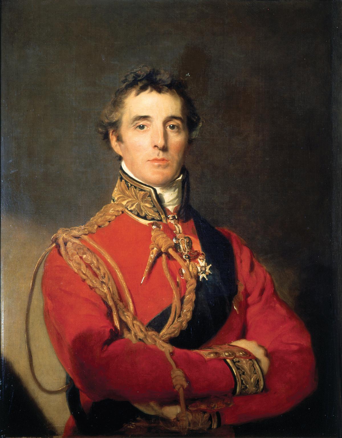 The General in a red tunic decorated with gold braid, with arms crossed across his chest