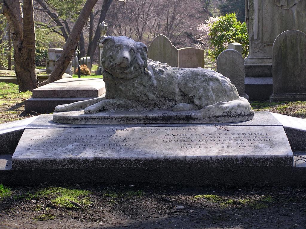 Photograph of a headstone, a marble dog