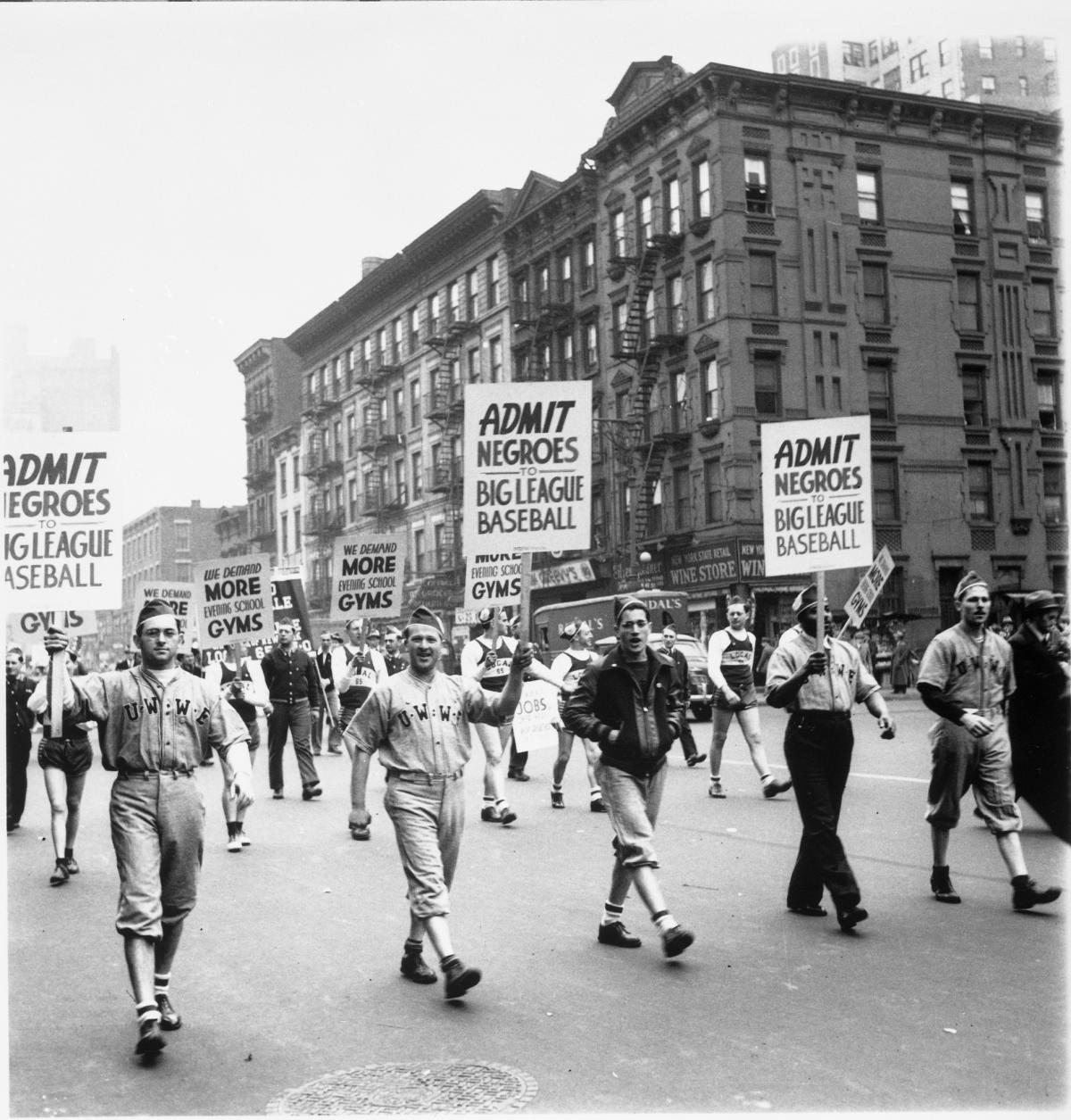Protesters march in the streets holding signs