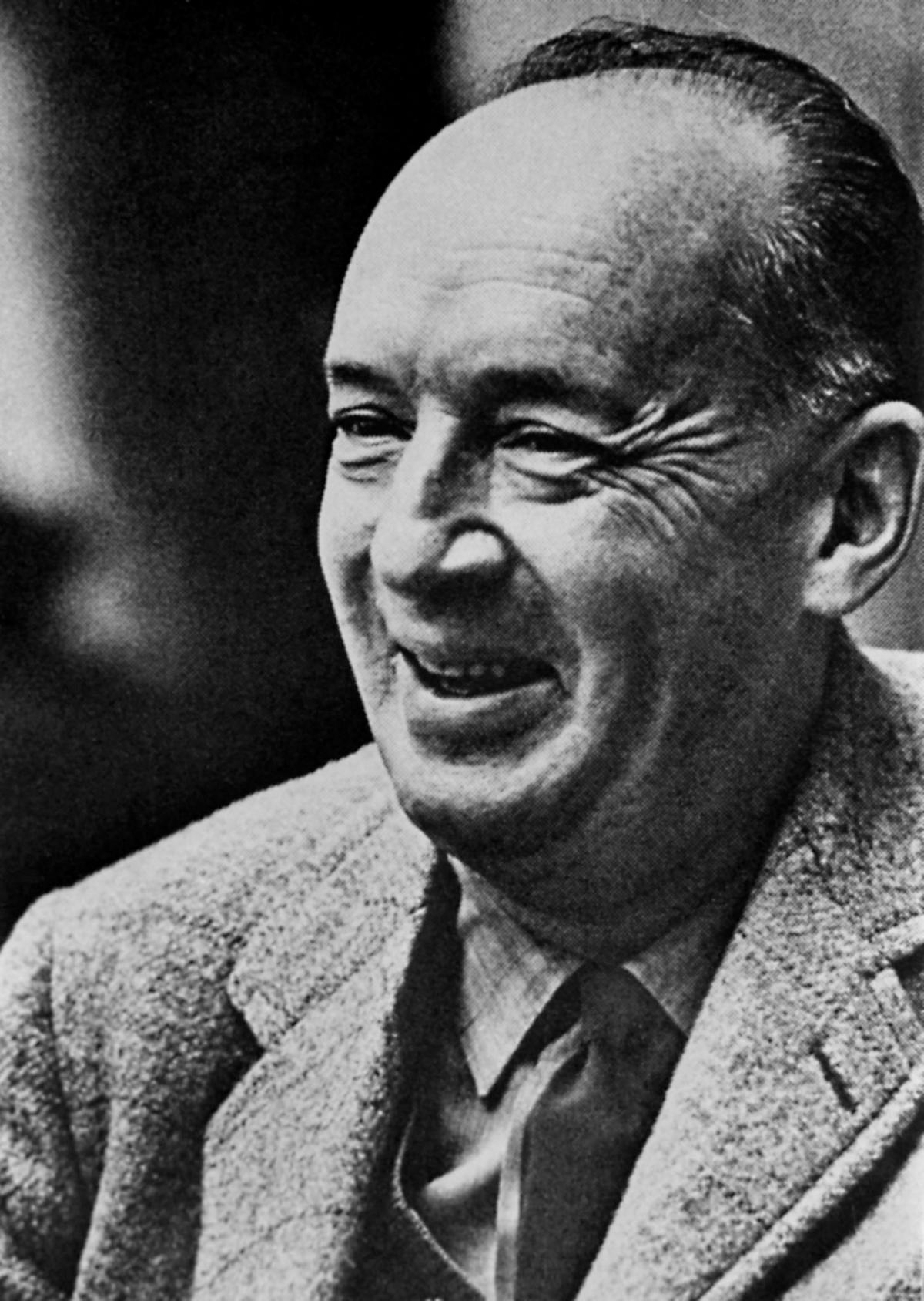 Head and shoulders photo of Nabokov, clean shaven and in a grey suit, striped tie