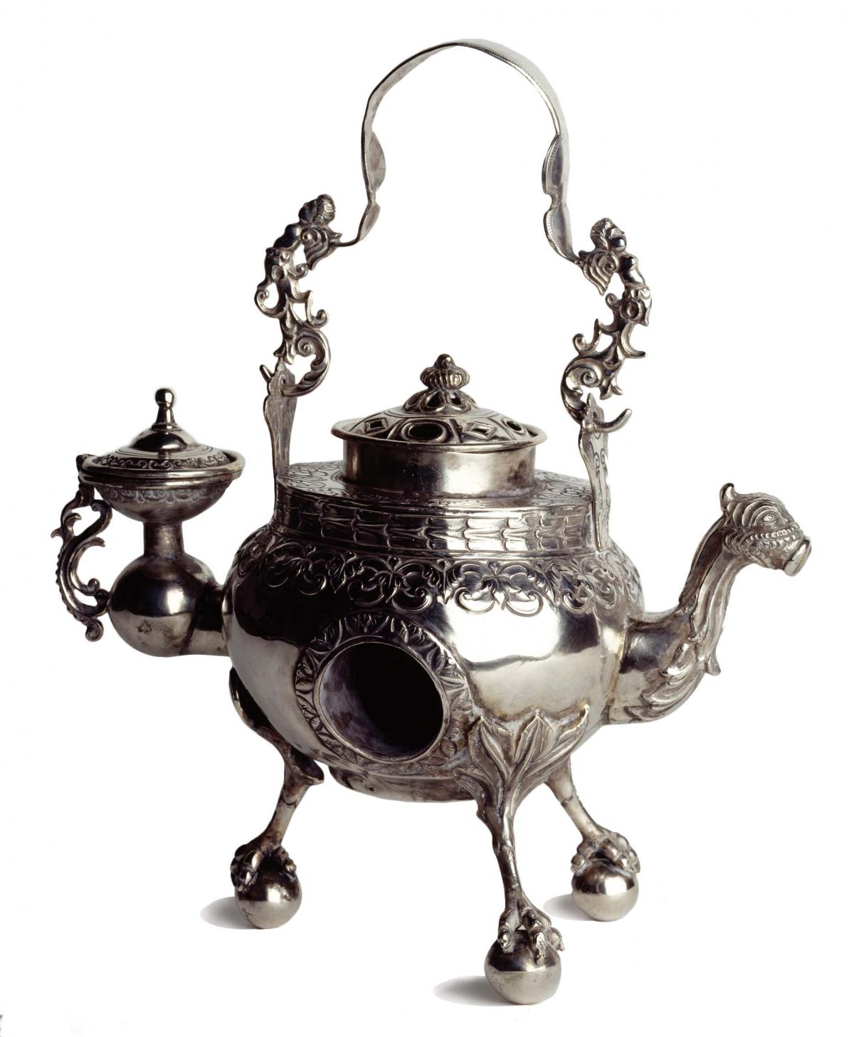 Silver water heater, with a camel head for a spout and hoofed legs for stands, with elaborate filigree work