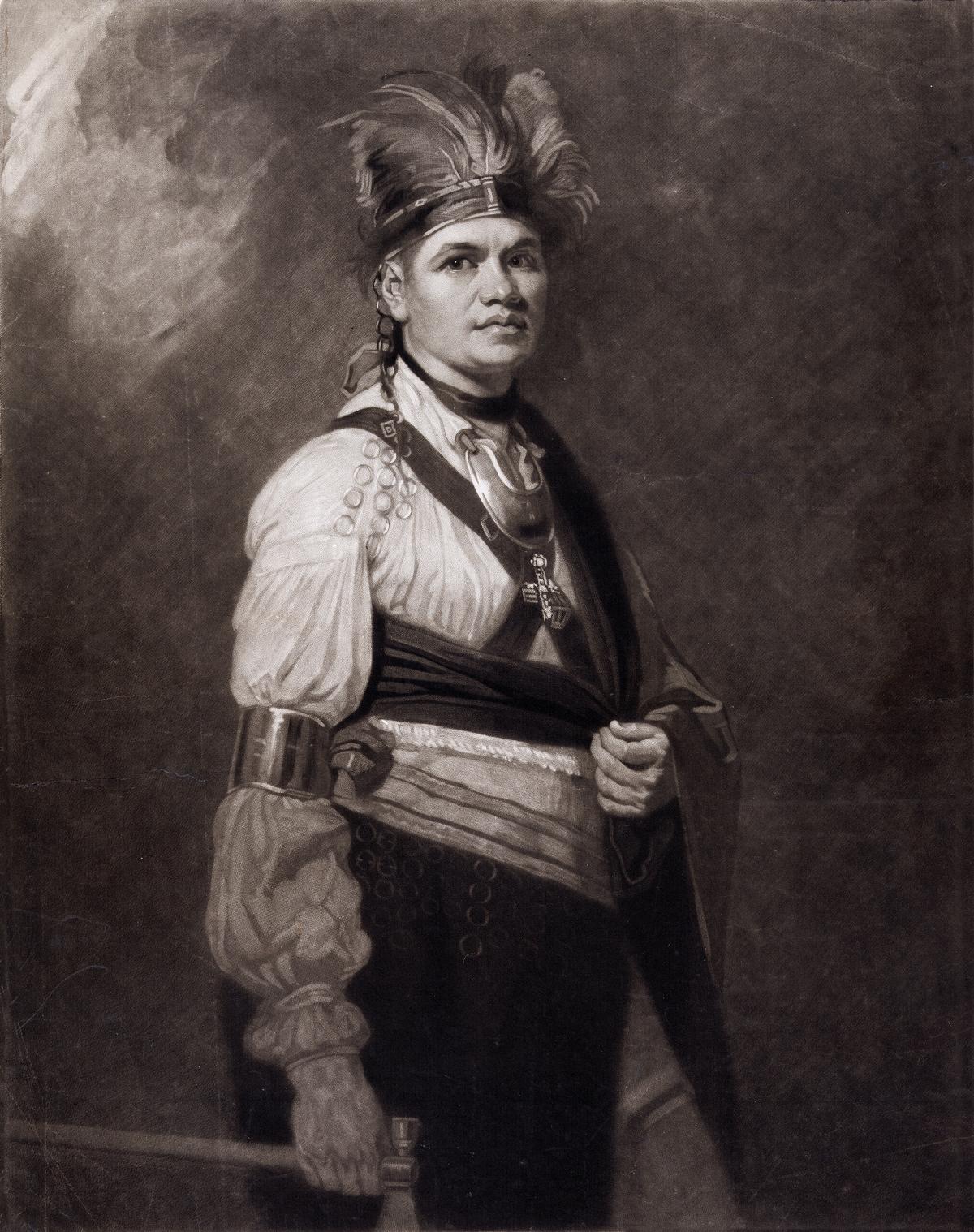 Joseph Brant, wearing a feathered Native American headdress and adornments, but also European-style shirt and trousers