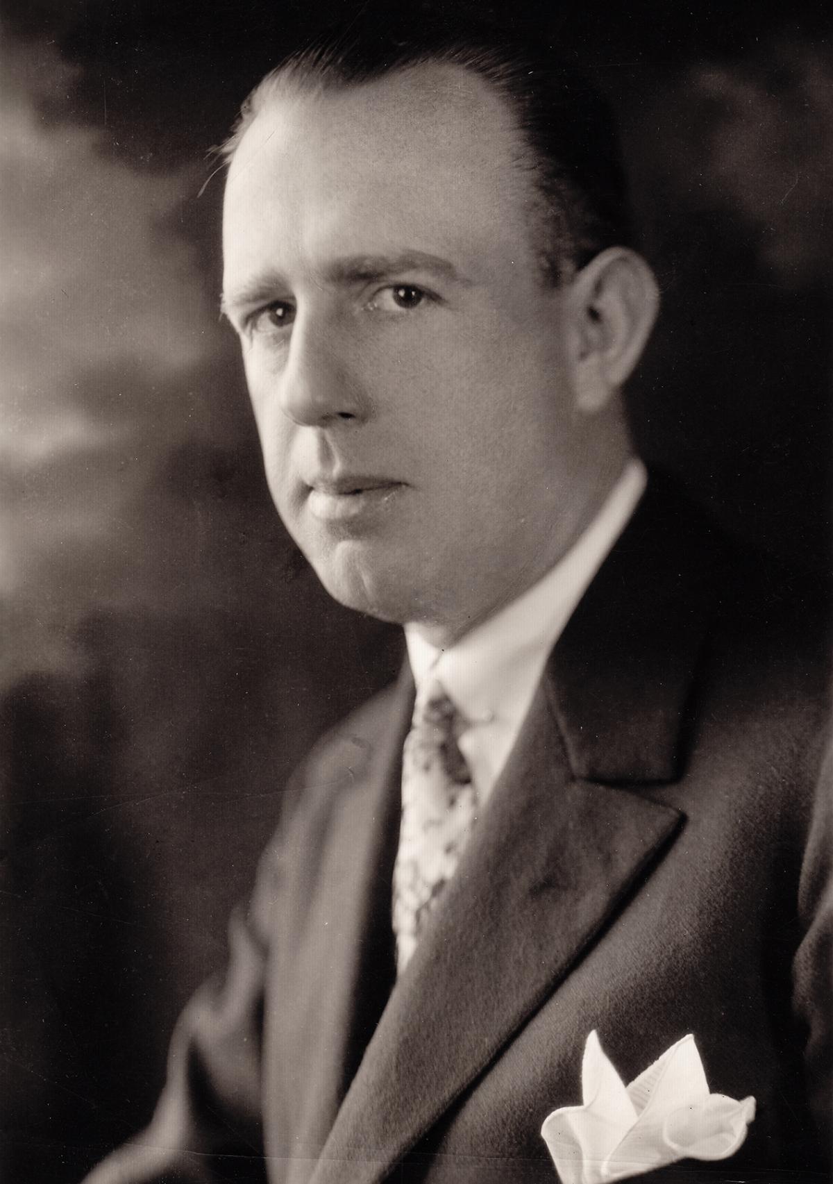 Shoulders-up photo of Powel Crosley, wearing a suit and pocket square