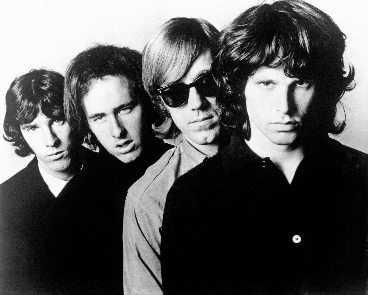 Black and white photo of various rock stars from the 1960s and 70s, including Jim Morrison.