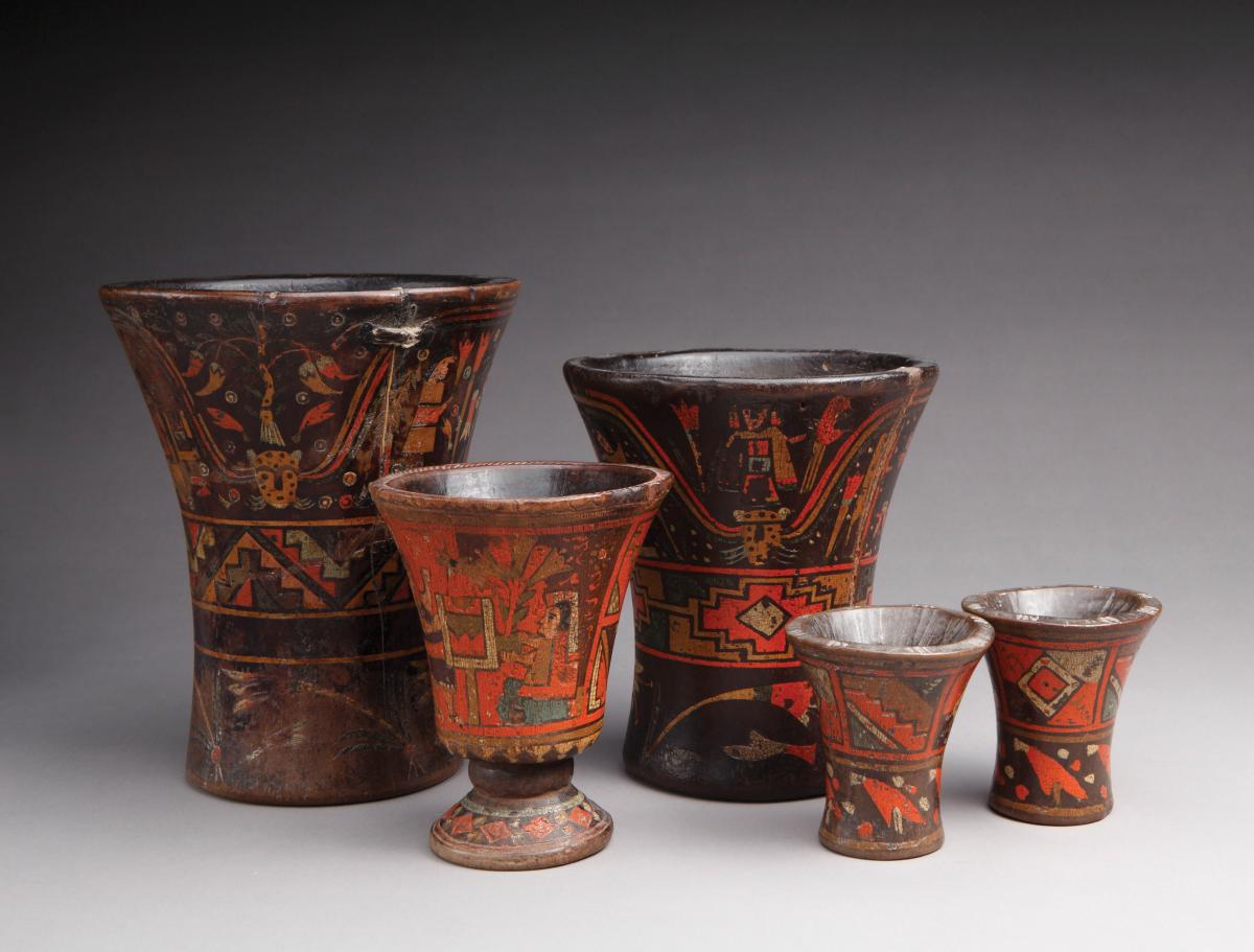 Set of five beakers, varying sizes, glazed in red, with wide mouths