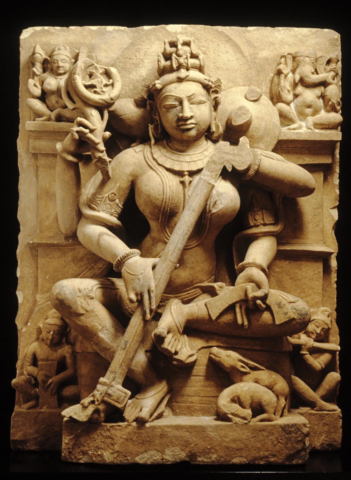 Sarasvati, goddess of speech, learning, and the arts, sculpted in sand-colored stone