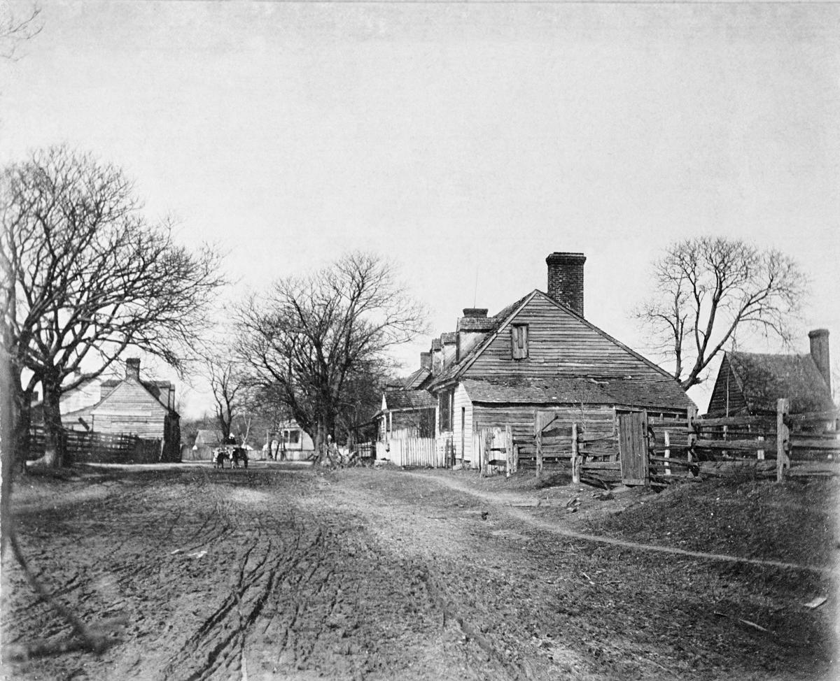 Francis Street, circa 1890: dirt road, wood slat houses, bare trees