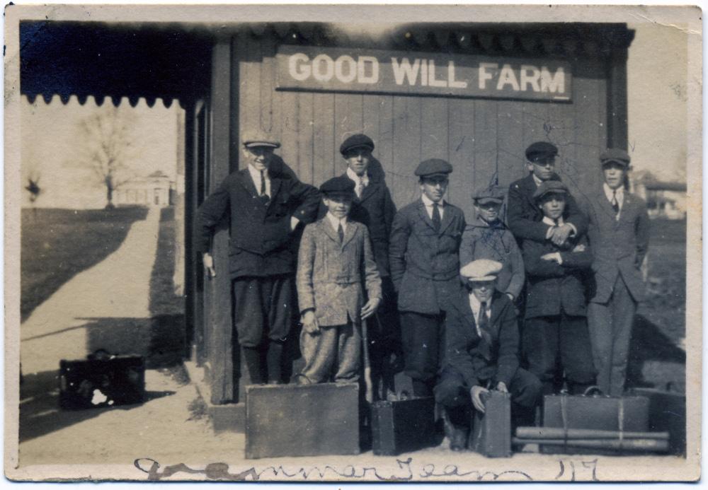photo of boys at train station with luggage