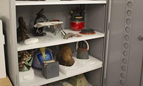 open storage cabinet filled with artifacts