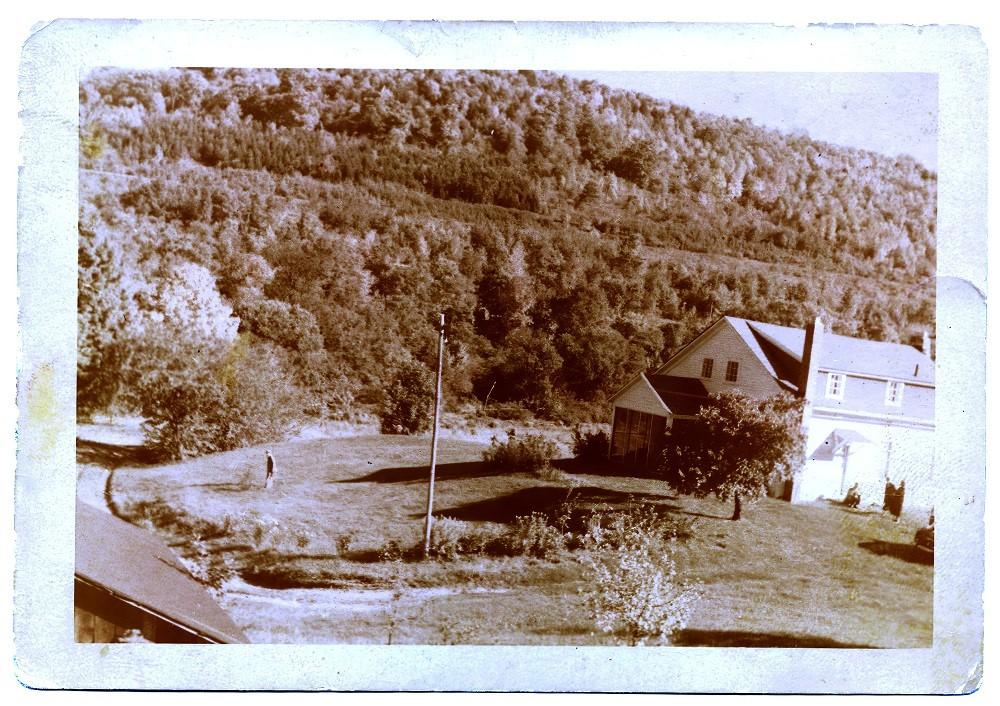 Historical photograph of Dennis Farmhouse looking east from hillside