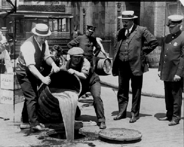Prohibition agents pour liquor into sewer, 1921 