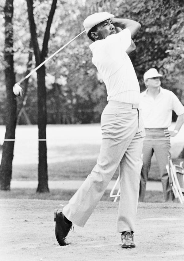 Black and white image of Calvin Peete swinging golf club