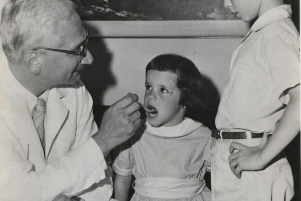 Dr. Sabin administers his oral vaccine to two Cincinnati children, ca. 1960.