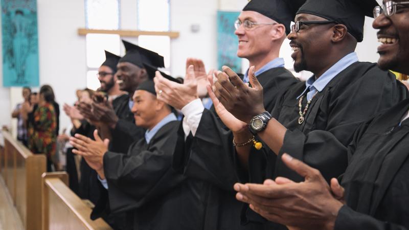 Graduates of the Prison University Project, clapping