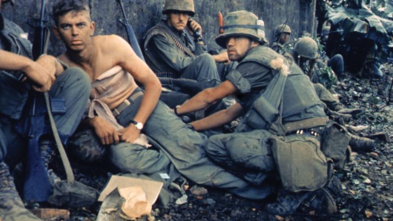 Marine D. R. Howe treats PFC. D. A. Crum's wounds during the battle for Hue