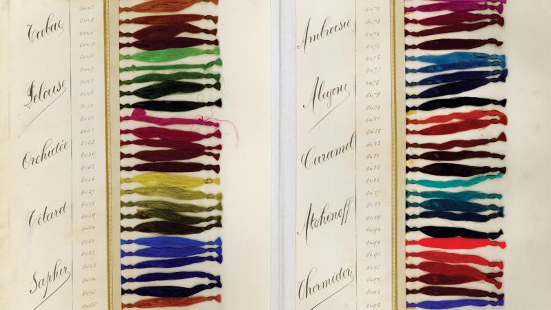Two columns of a rainbow of colored thread bundles, each labeled with the name of their hue