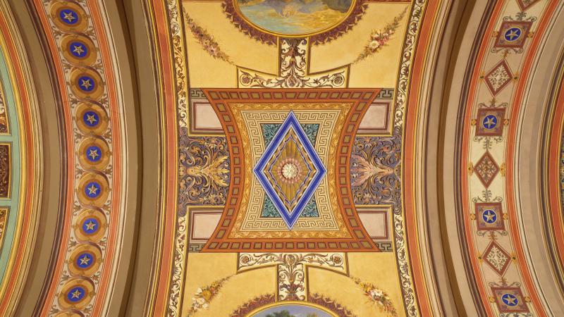 Photo of a colorful and ornate mosaic adorning a vaulted ceiling in the Senate building.