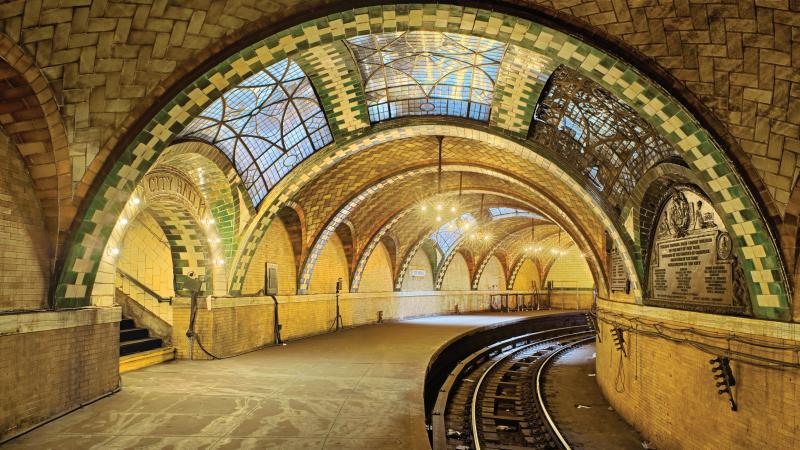 Photo of the New York city hall subway station, which boasts an ornate vault with stained glass windows.