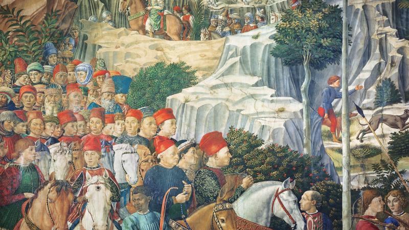 Procession of men and horses on a winding mountain path