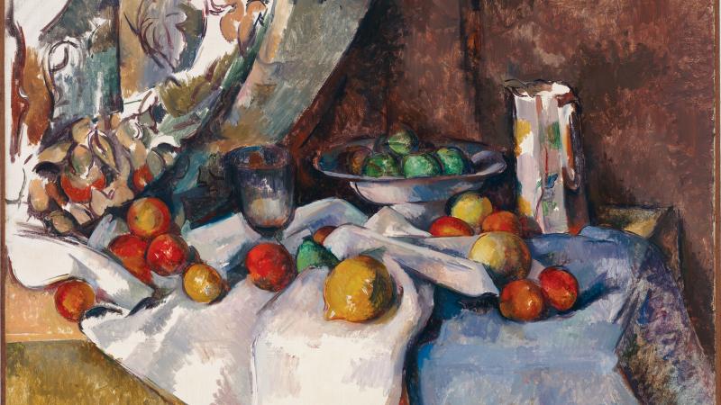 Still-life painting of a variety of fruits (apples, peaches, and others) set out upon a table draped with linens.