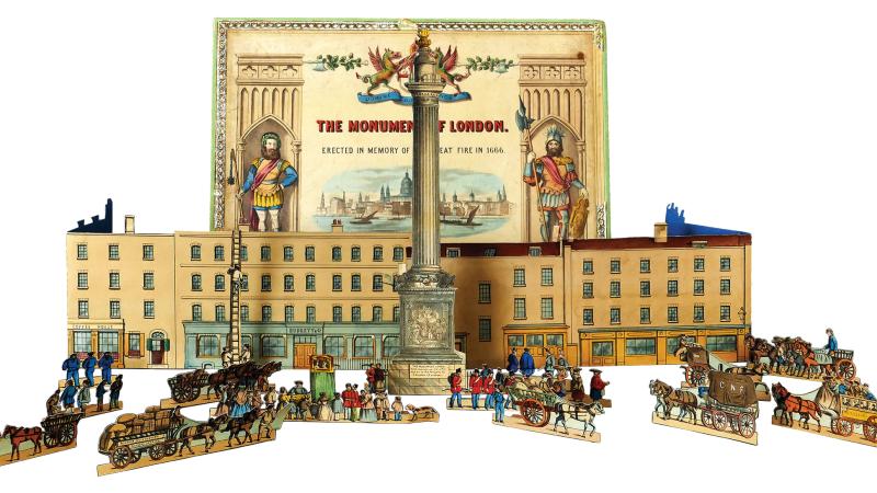 Color photo of a toy set of the Monument of London, including figurines and a building.