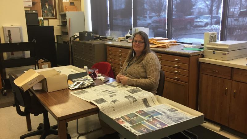 Michele Wheeler working on identifying Vernal Express photos using newspapers.
