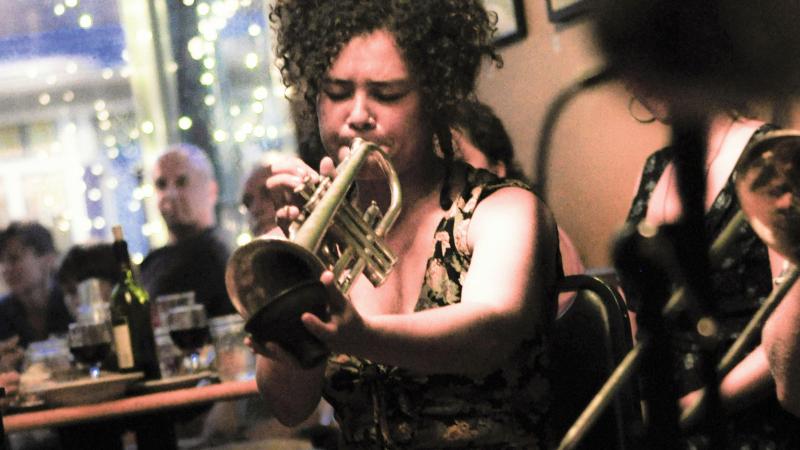 Shaye Cohn of Tuba Skinny with Tupelo the dog at the Rosendale Cafe in New York.