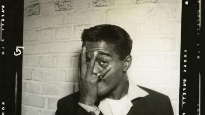 A backstage photo of Sammy Davis Jr. playfully blocking his face with his hand