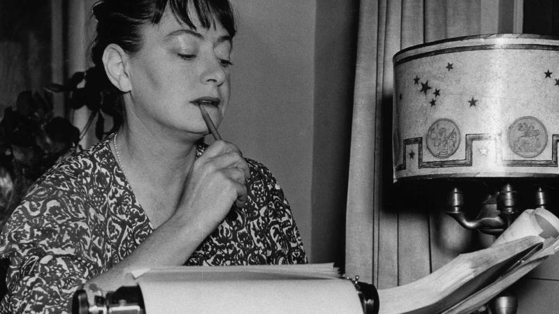 Pensive Dorothy Parker at typewriter