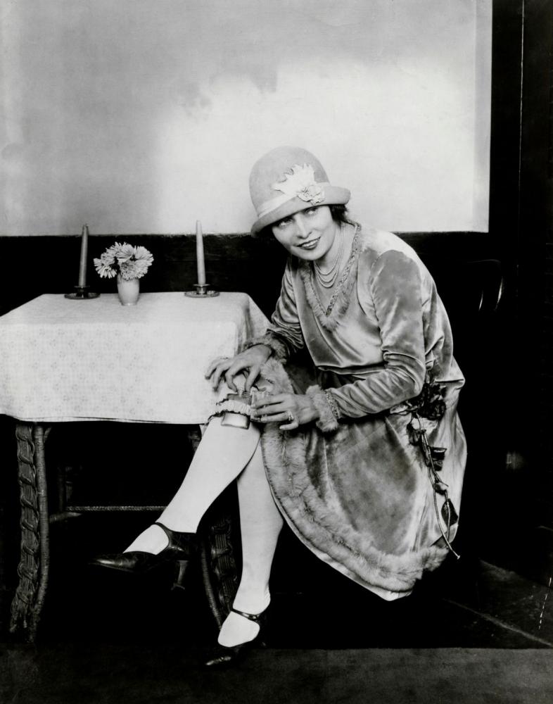 woman with a flask hidden in her garter during prohibition, 1926